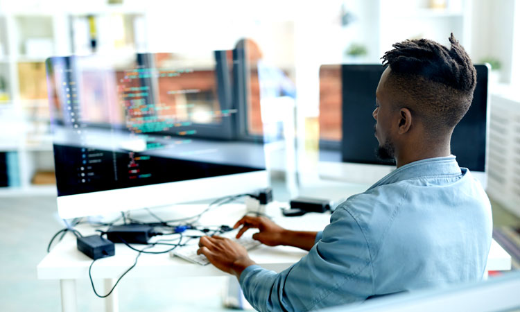 Man coding at a computer