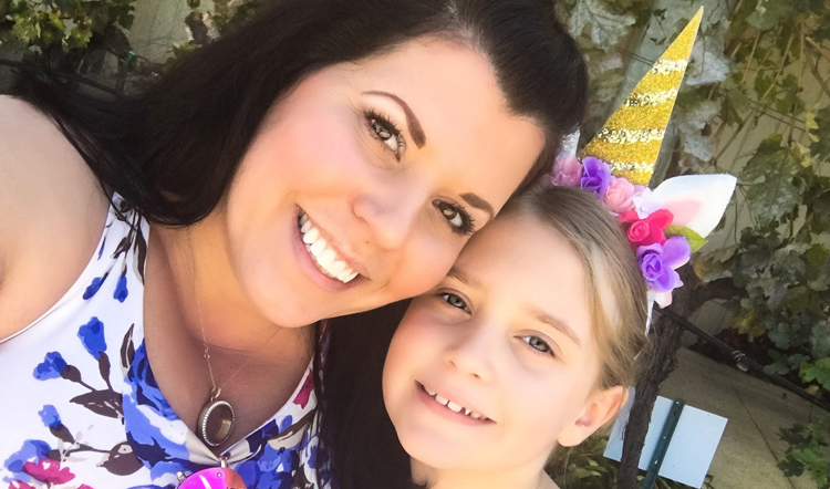 Photo of a woman smiling next to her daughter