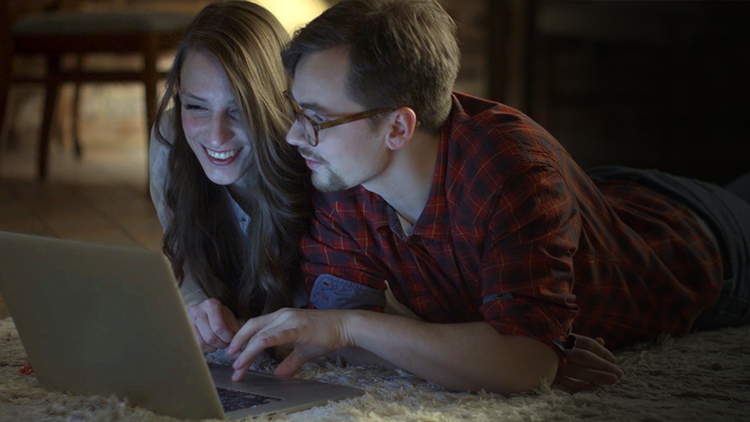 Two People Looking at Laptop