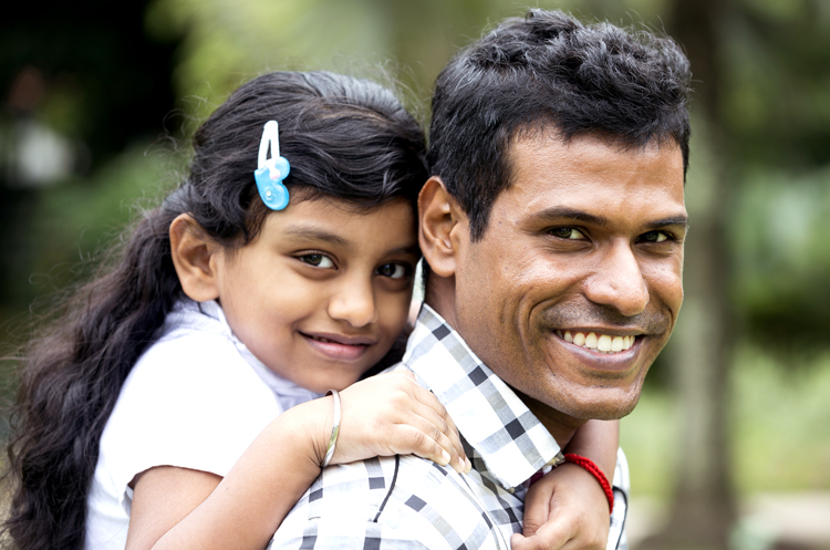 Father and daughter smiling at camera