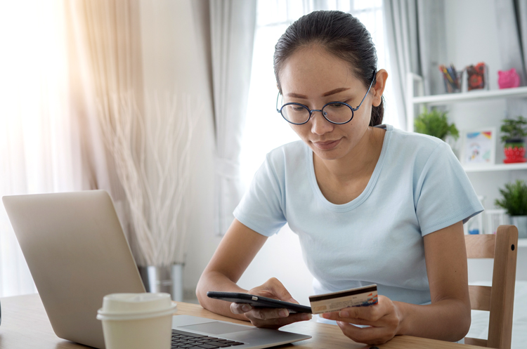 Woman holding her cellphone and credit card