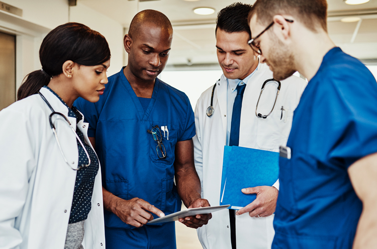 medical staff looking at digital data