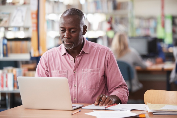 man looking at laptop computer