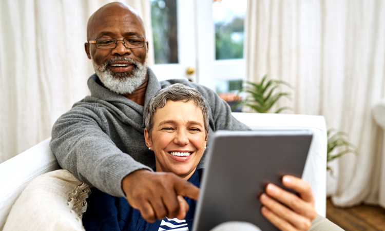 Man and woman pointing at a tablet