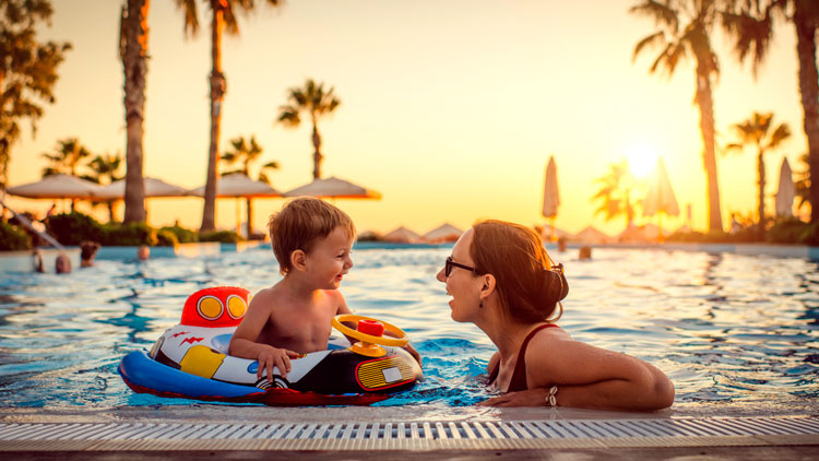 Woman and child in a swimming pool in summer