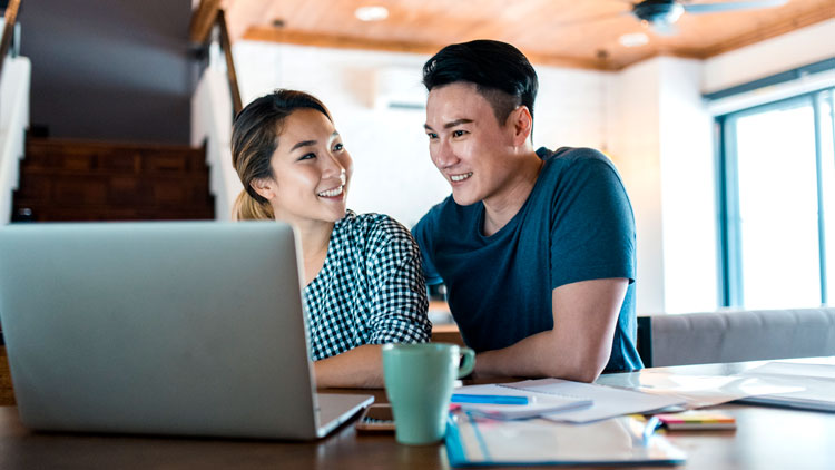 Two people looking at laptop